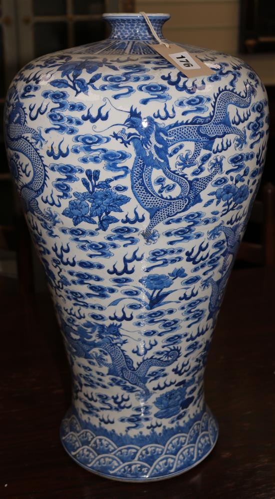 A tall Chinese blue and white dragon vase